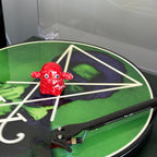 Red Vinyl Ghost spinning on a green picture disc vinyl record