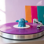 Series 002 Vinyl Ghost spindle topper spinning on a purple vinyl record