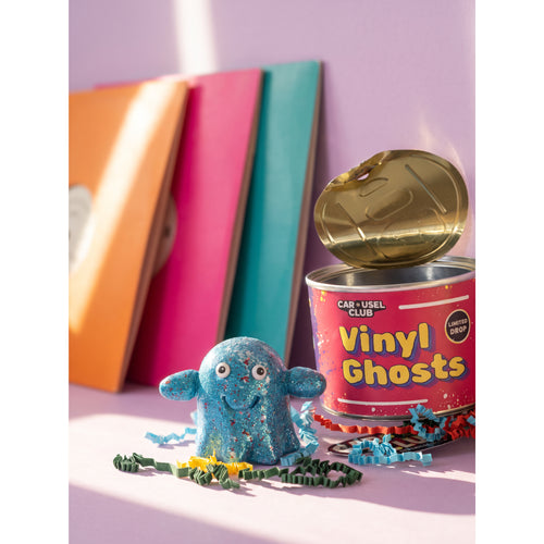 Series 002 Vinyl Ghost beside its open Carousel Club collectible tin