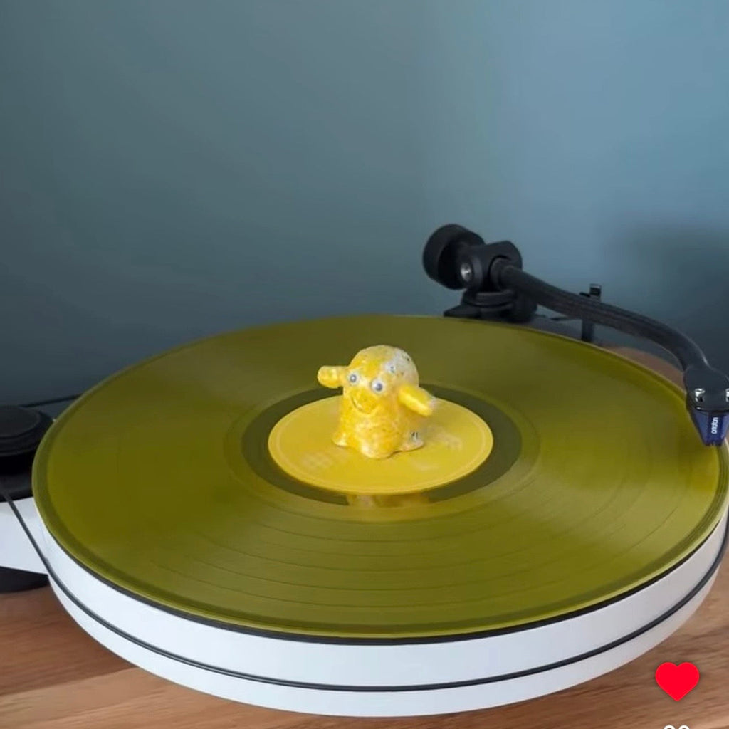 Yellow Vinyl Ghost collectible figure on a coloured vinyl record player setup