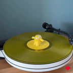 Yellow Vinyl Ghost collectible figure on a coloured vinyl record player setup